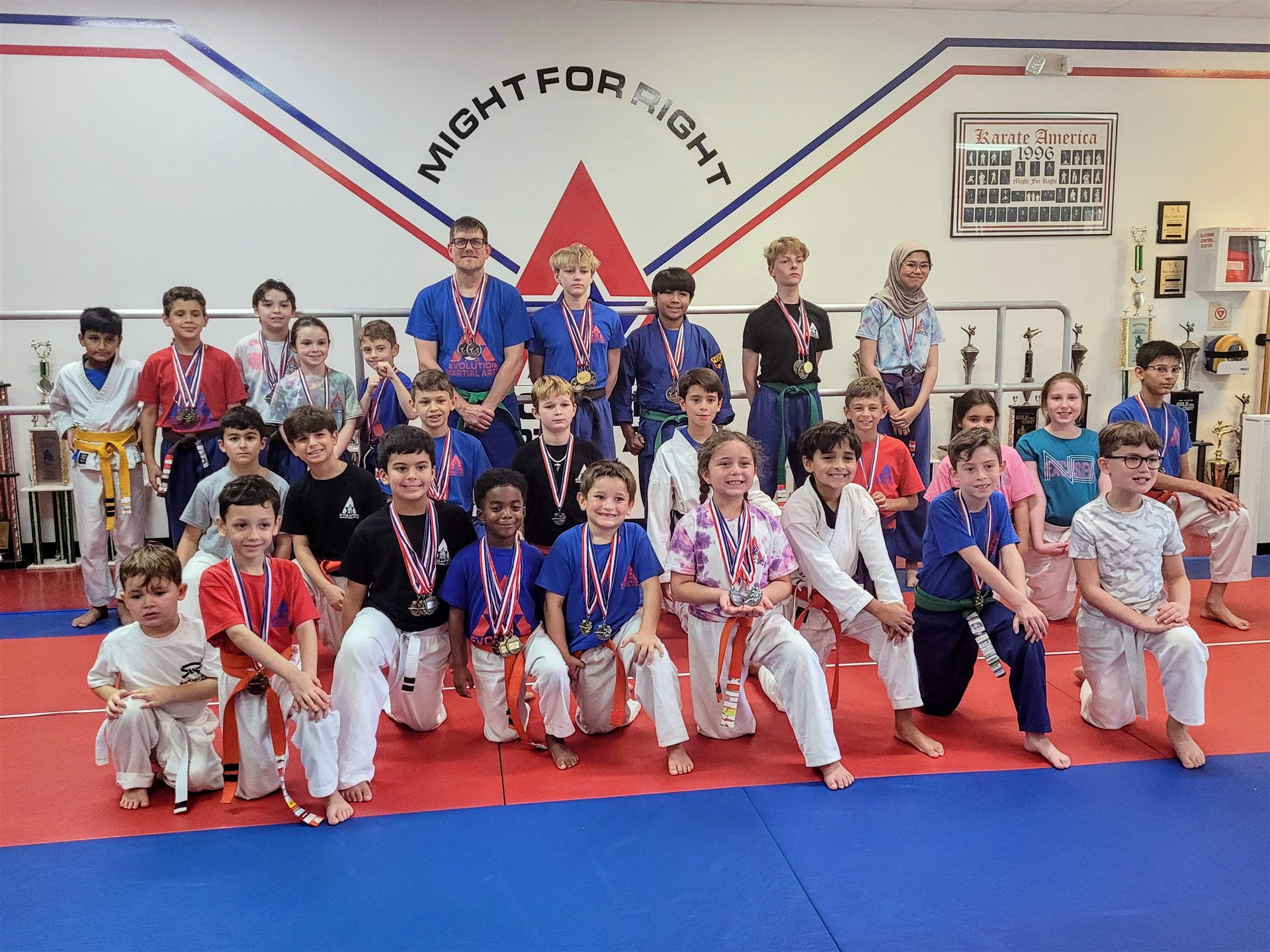 Evolution Martial Arts students with their tournament medals